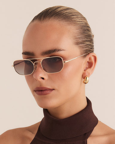 Women's sunglasses with metal gold frame, double bridge design and tinted lenses