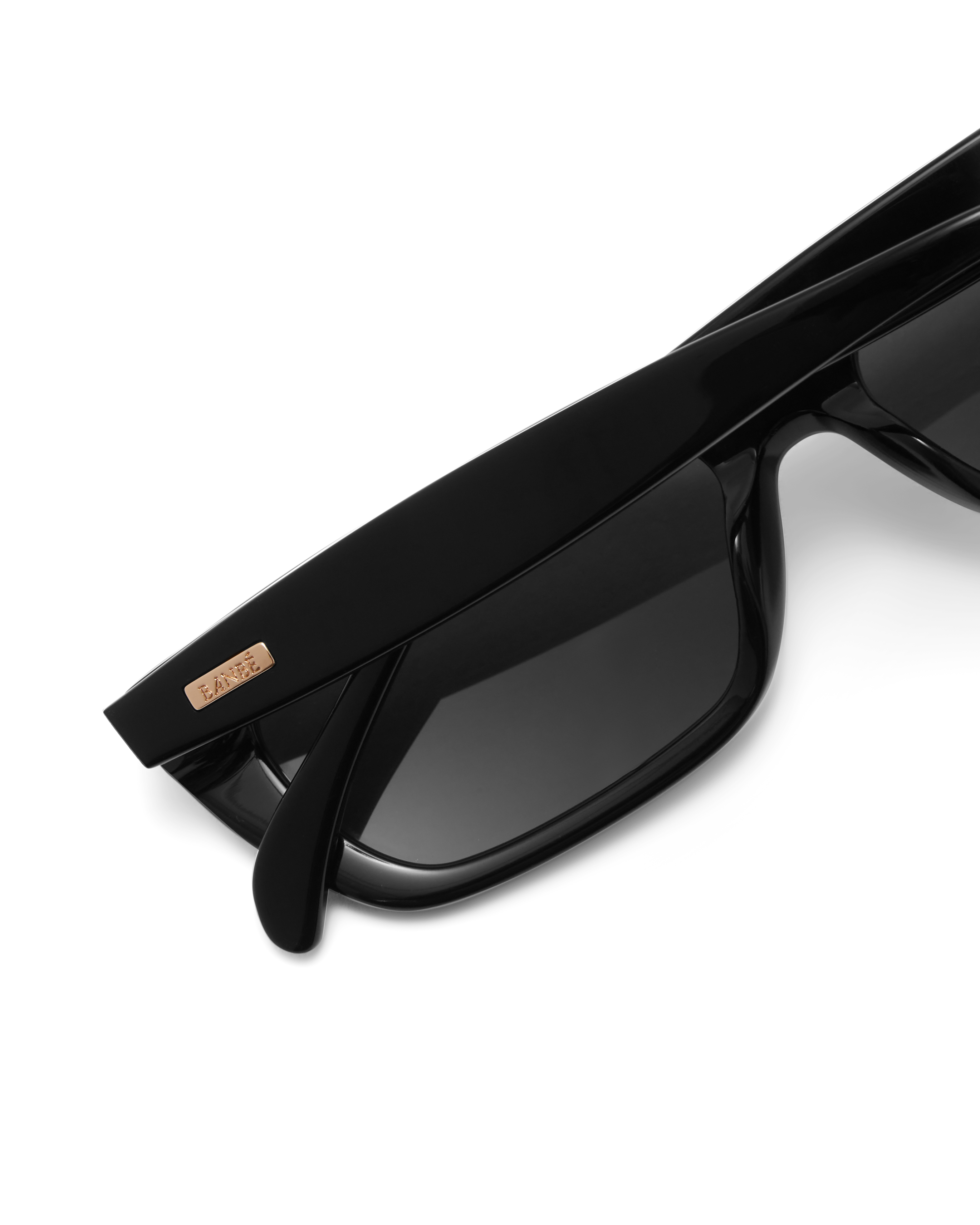 Black sunglasses with dark lenses on a white background.