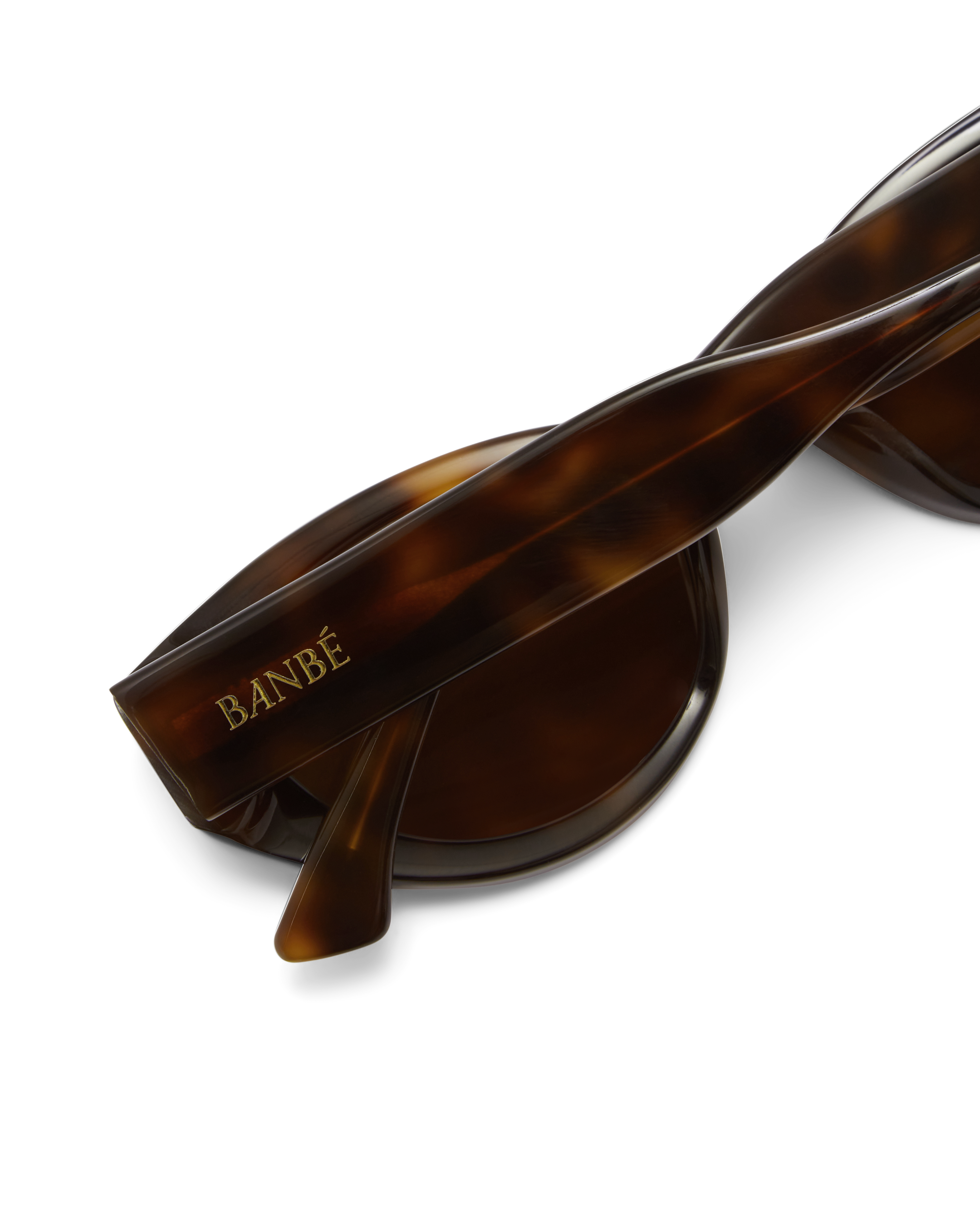 Sunglasses with tortoiseshell frame and brown lenses on a white background