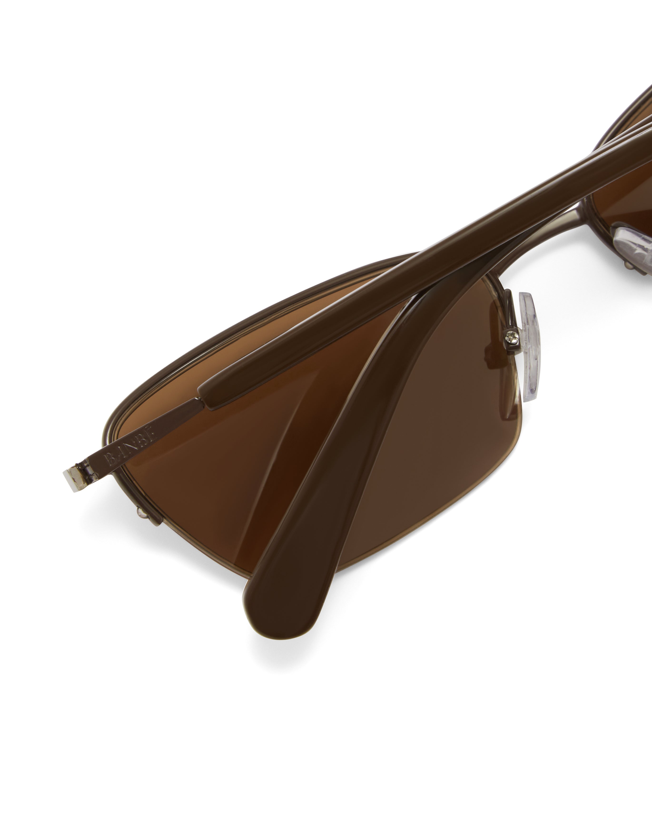 Women’s metal cat-eye sunglasses with UV protection, thin frame, brown tinted lenses, close view