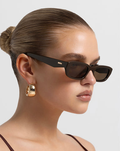 Women’s rectangular sunglasses with tonal tinted lenses, chunky acetate frame, UV Protection, side view on model.