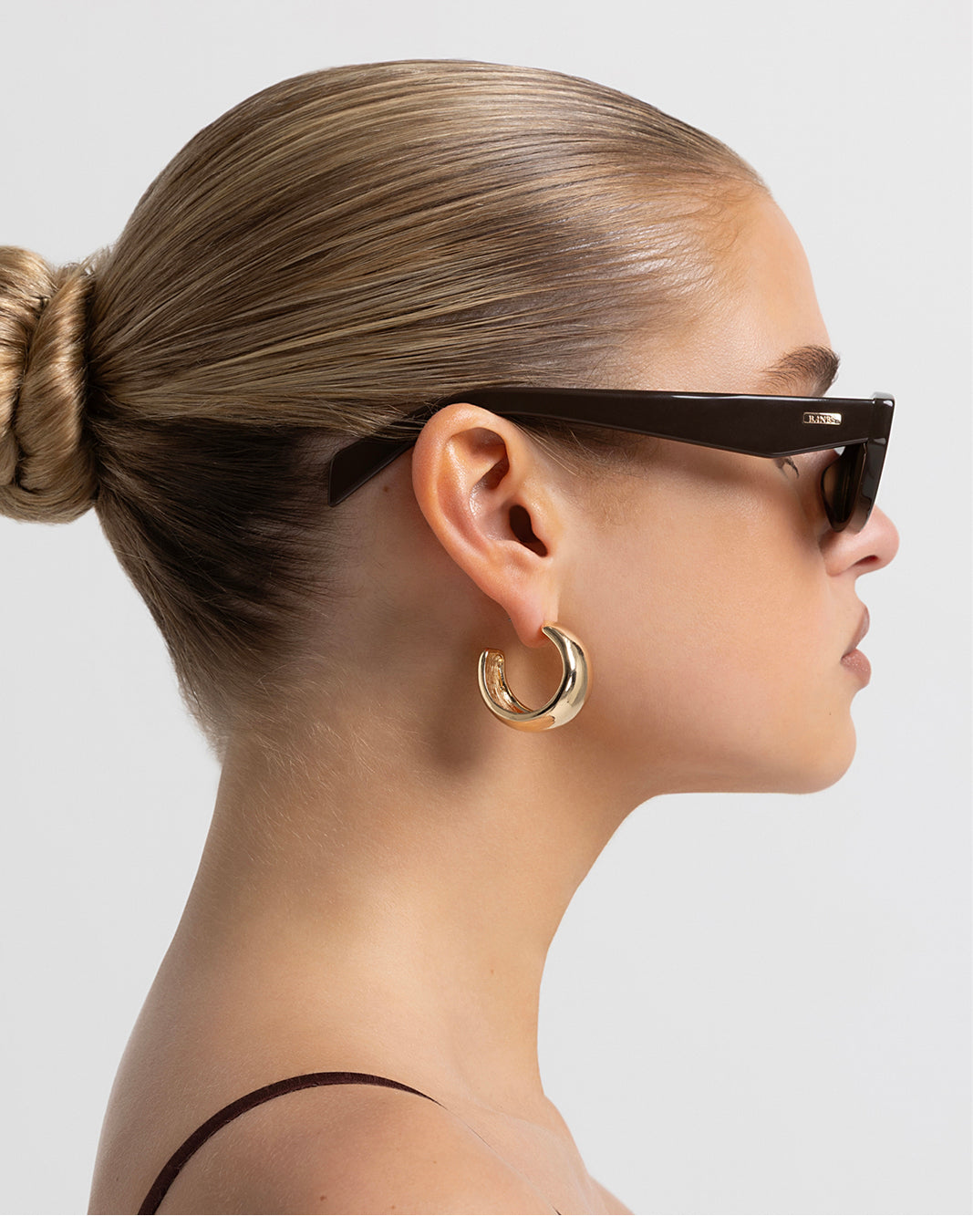 Women’s rectangular sunglasses with tonal tinted lenses, chunky acetate frame, UV Protection, side view on model.